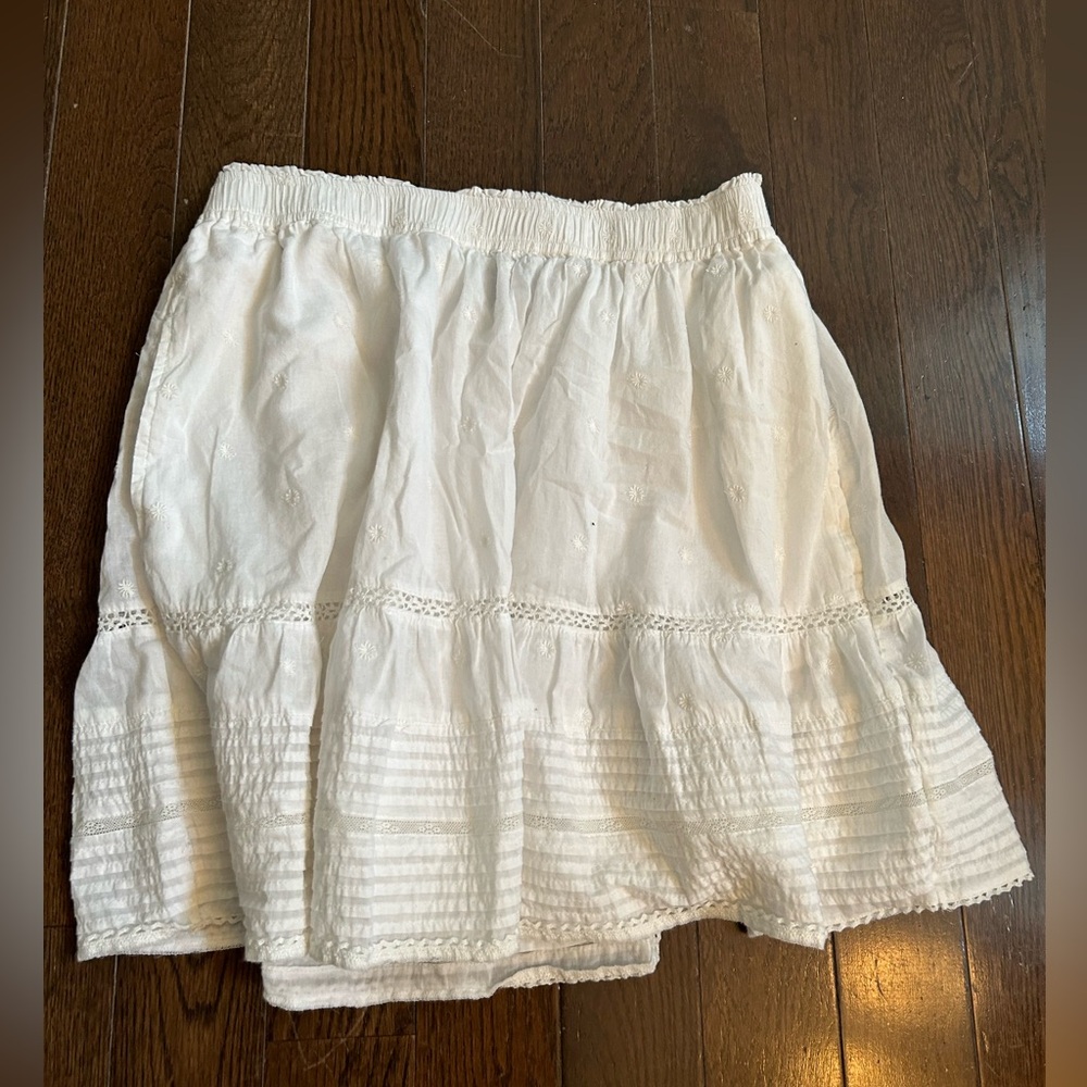 White cotton mini skirt with pockets and eyelet detail